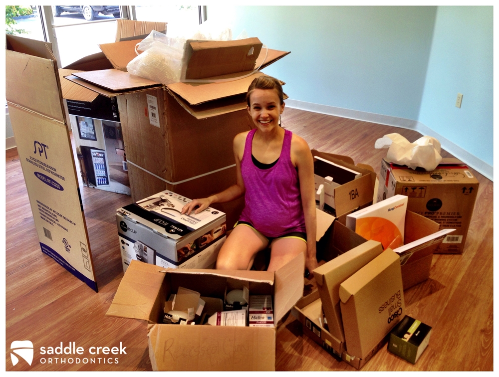 Surrounded by boxes OR We couldn't have done it without you Amazon