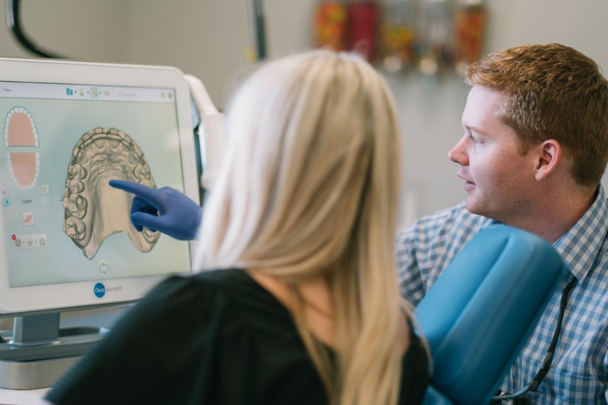 Dr. Kyle showing a patient their dental scans